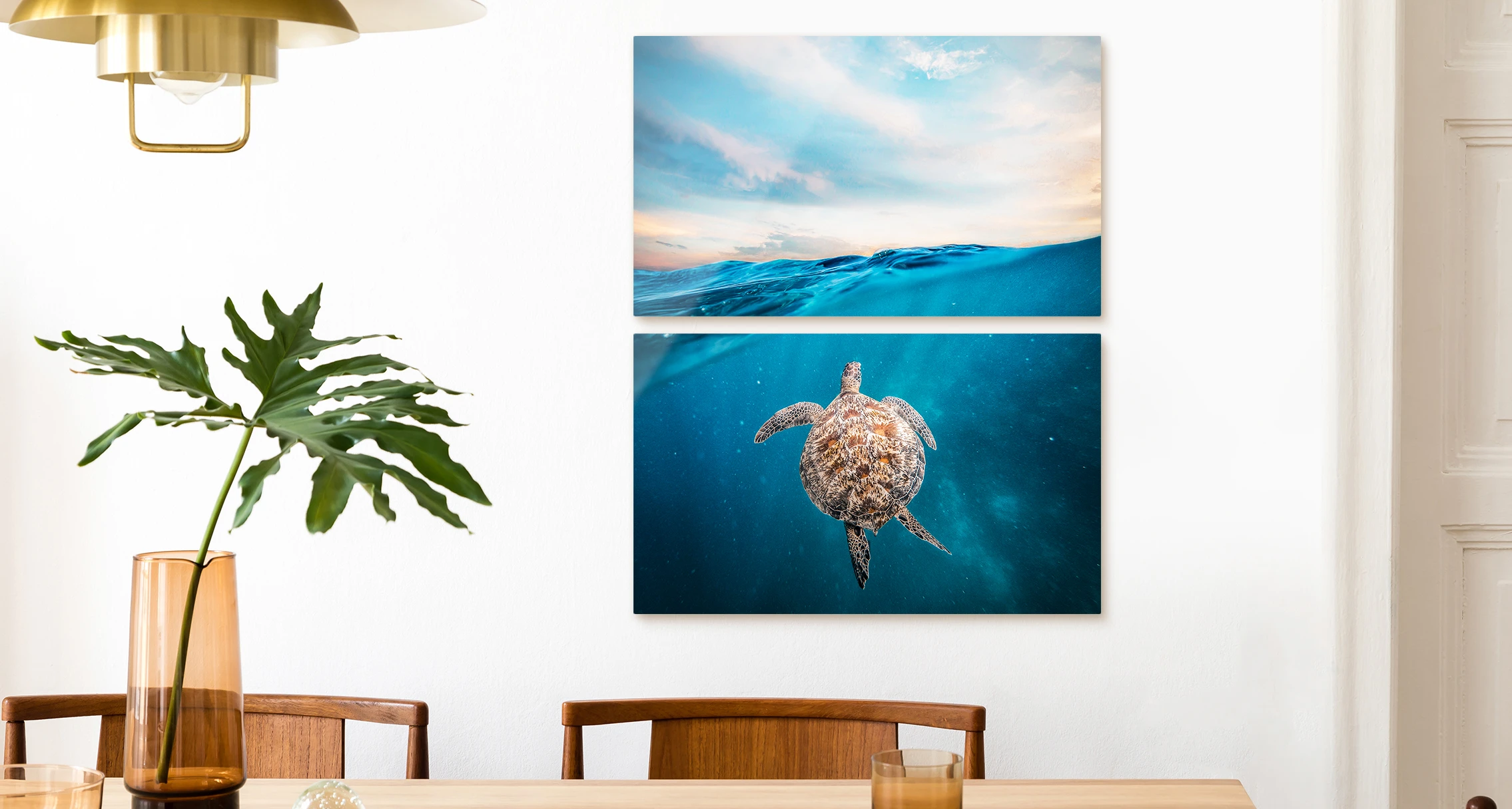A turtle swims just below the surface of the sea. The whole picture is divided into two parts that hang vertically on the wall. 