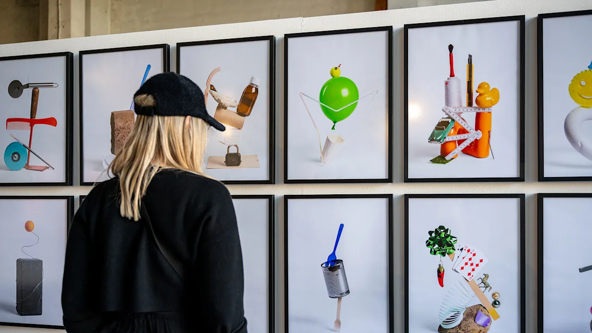 WhiteWall x BFF Scholarship Exhibition A blonde woman in a black cap views a gallery wall of framed photos featuring colorful everyday objects arranged creatively.