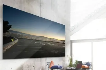 WhiteWall Masterprint WhiteWall Masterprint on a concrete wall, showing a panoramic shot of a sunset over a city.