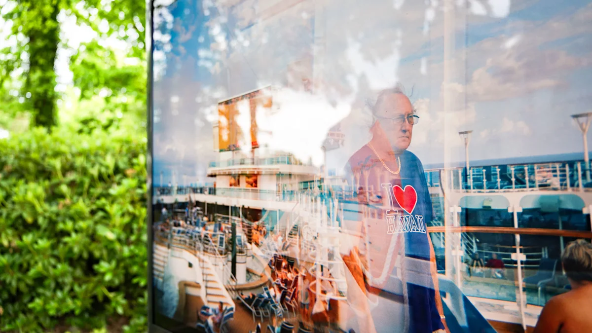 ChromaLuxe print exhibited outdoors in Zingst, Germany Outdoor exhibition showing a photo of a cruise ship deck with blue lounge chairs and "I Love Hawaii" sign