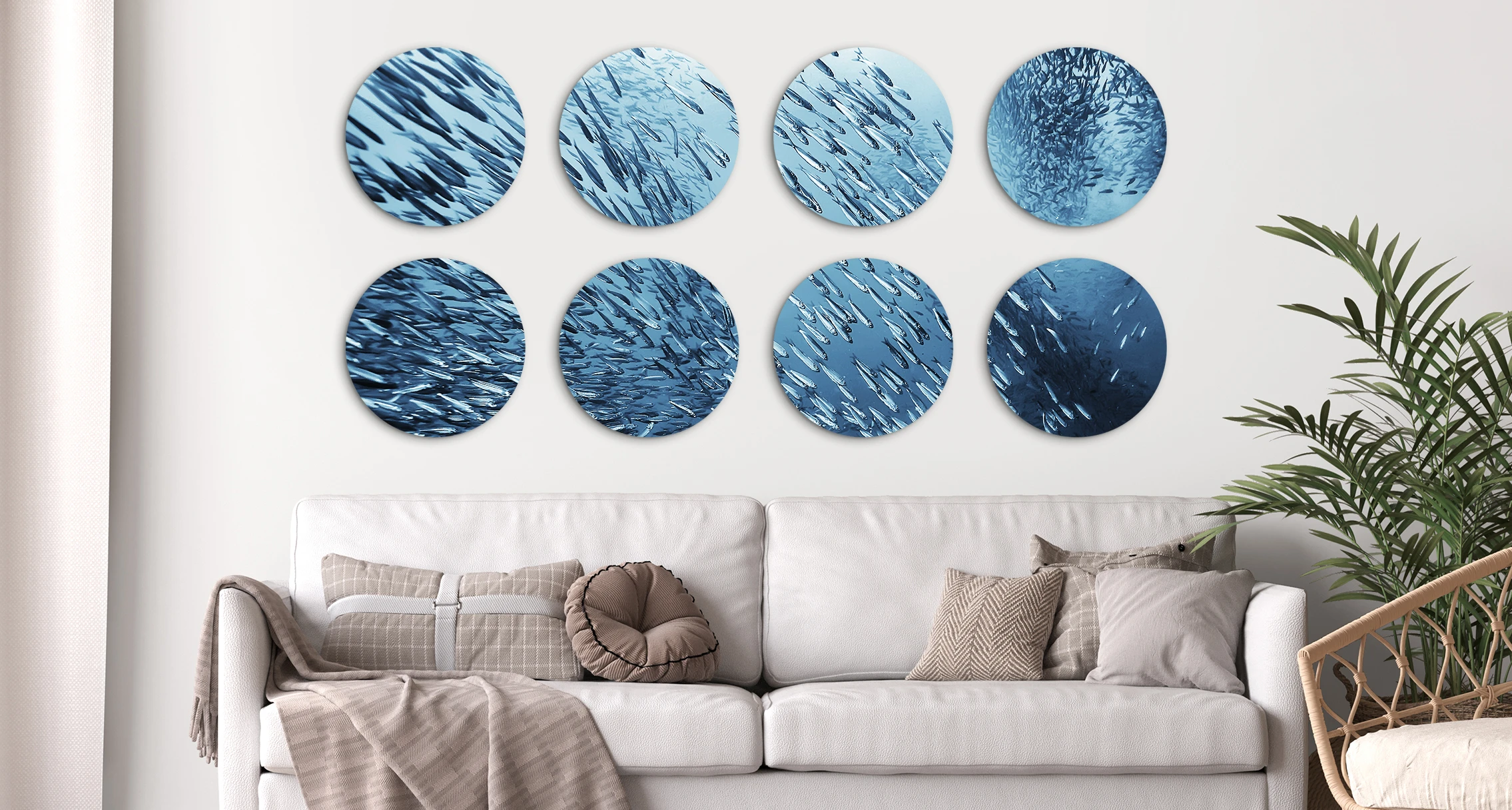 The motif of schooling fish can be seen on 8 different round pictures, which are hung next to each other in two rows on a wall. 
