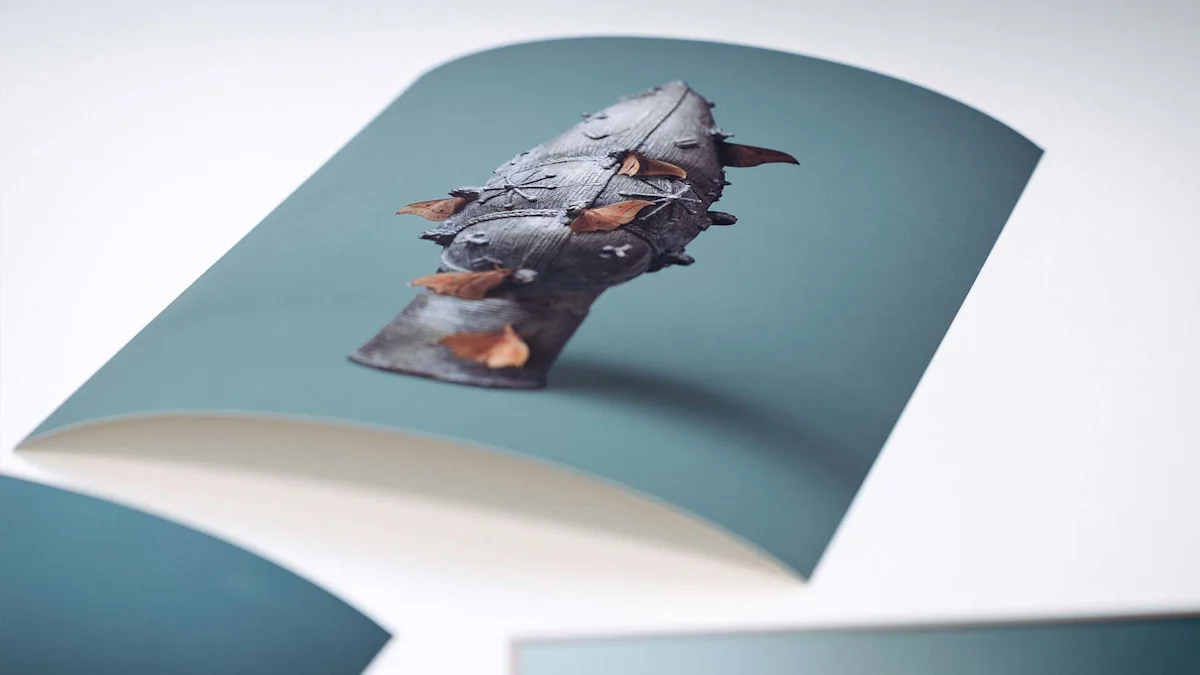Unframed fine art print The close-up photograph shows an unframed fine art print resting loosely on a white surface, its edges curling slightly upward. The printed motif features the historic bronze object with brown moths against the characteristic teal background. This curvature of the paper casts a soft shadow onto the bright underground, emphasizing the physical quality of the print. In the lower area of the image, the cropped edges of other prints are visible, while the focus remains entirely on the central artwork.