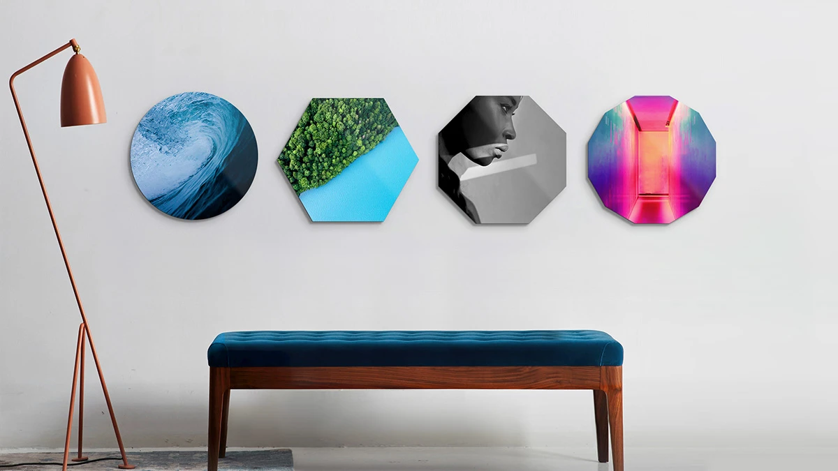 4 differently shaped wall prints hanging on a wall.