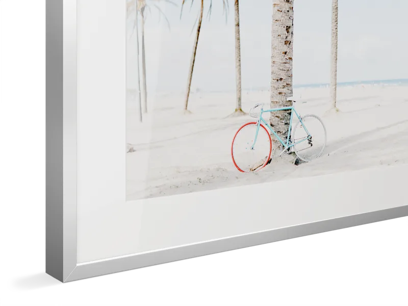 Close-up of silver Magnet Frame with Light blue vintage bicycle with red wheel leaning against white birch trees in a minimalist winter scene