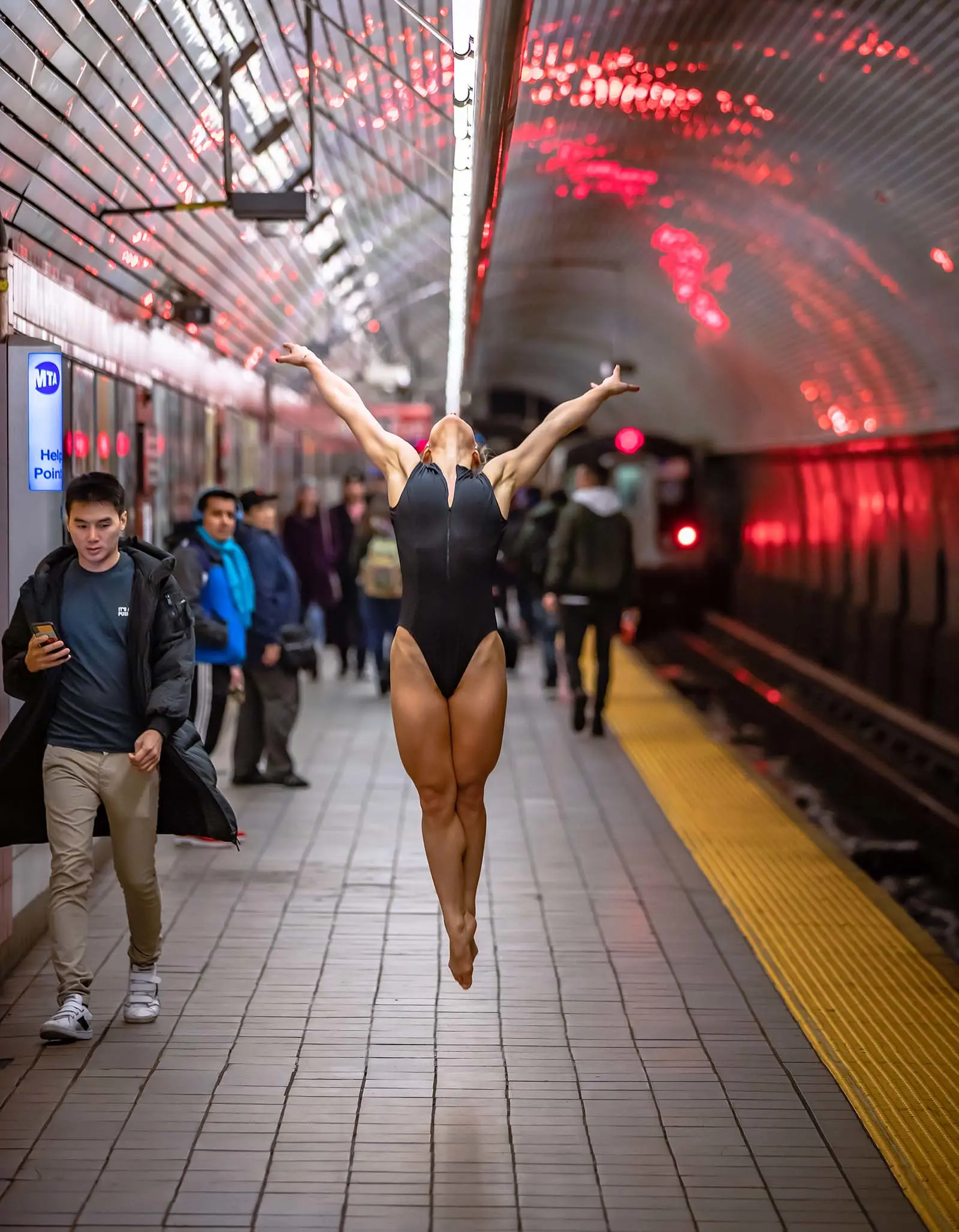 ballet dancer jumping in a subway station.