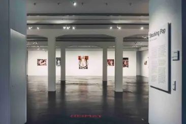 A look inside the “Shocking Pop” gallery View of the “Shocking Pop” gallery with several artworks on the walls and a row of columns in the room.