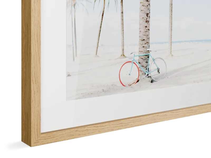 Light blue vintage bicycle with red wheel rims against white wall, displayed in natural oak Magnet Frame