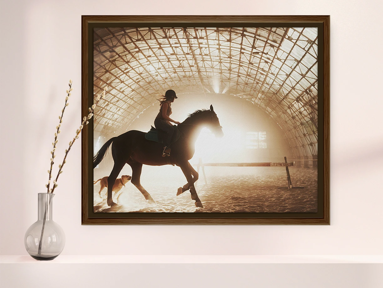 woman riding a horse as a matte canvas print in a solid wood floater frame hanging on a wall.