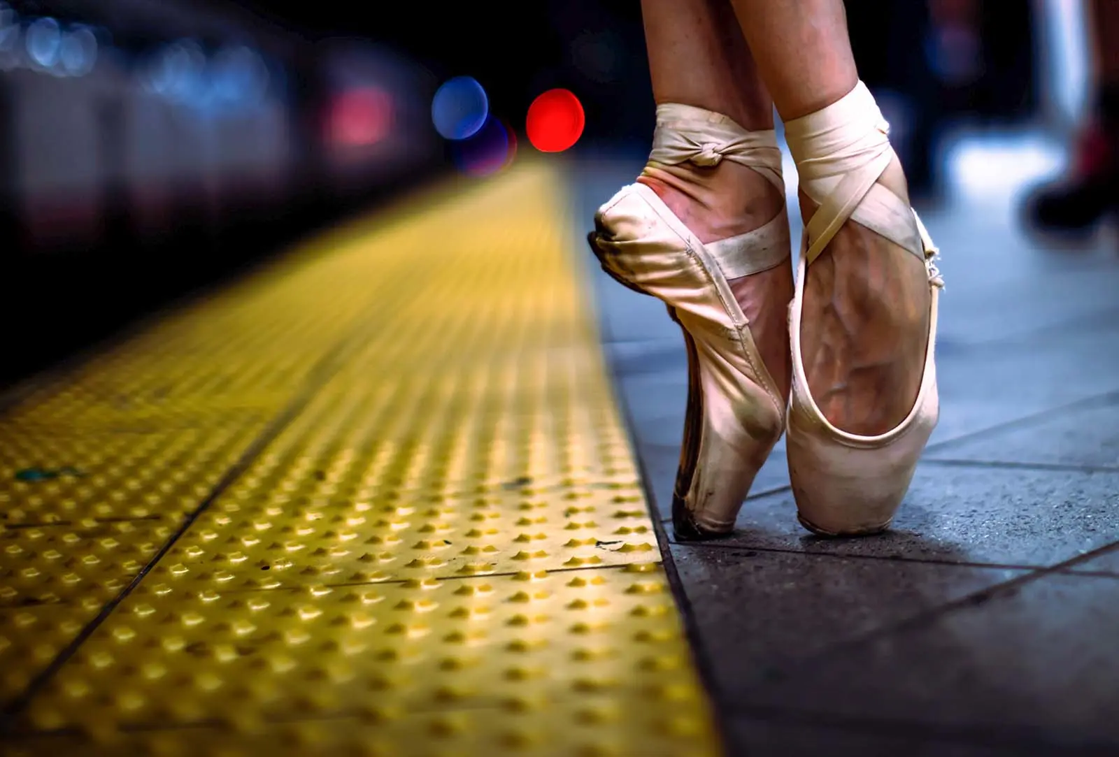 feet of a ballet dancer in a subway station.