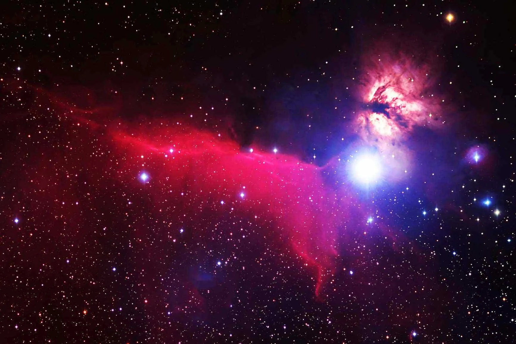 Deep-space photography of a red nebula Deep-space photography featuring a glowing red nebula, several bright stars, and a bright, radiant area in the upper right corner.