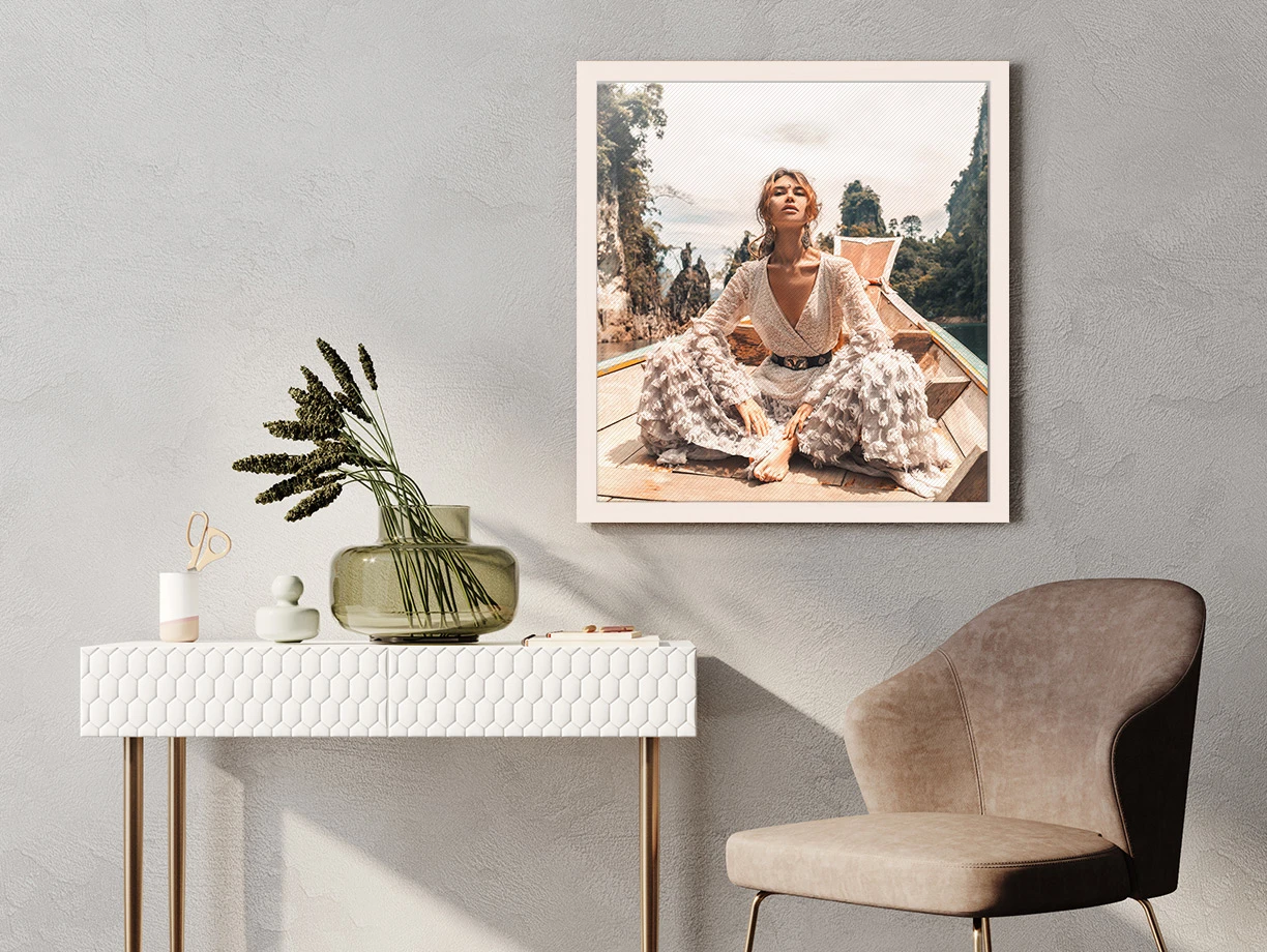 glossy canvas print in a solid wood floater frame hanging on a wall.