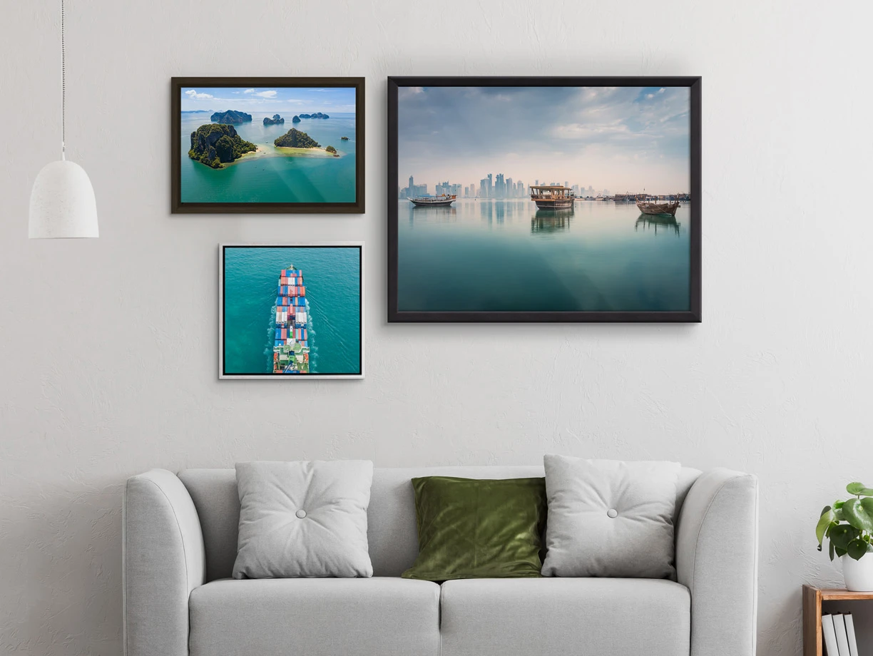 Several different motifs on  a Photo Print On Aluminum Backing with different frames hang on a wall in a living room.
