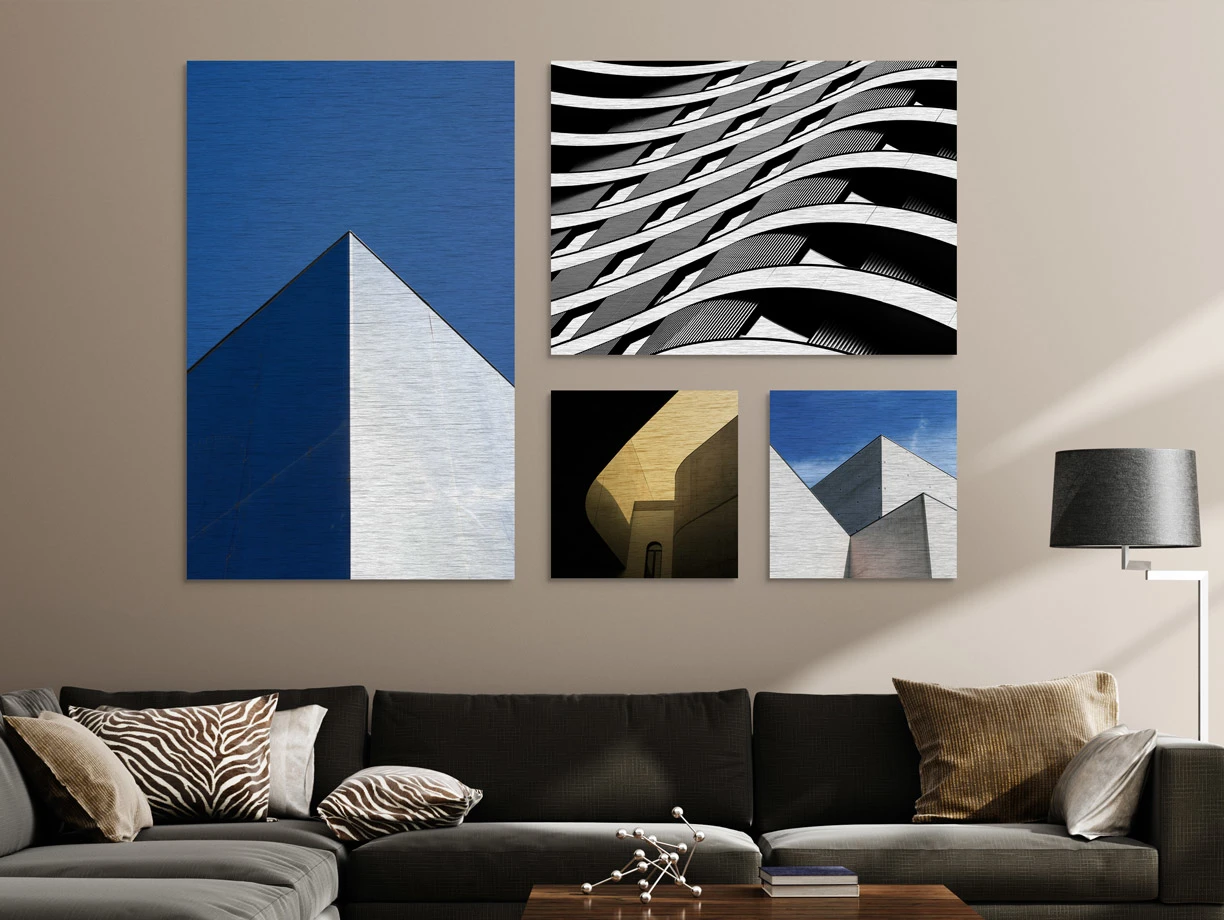 Several different motifs on a Photo Print On Aluminum Backing hang on a wall in a living room.