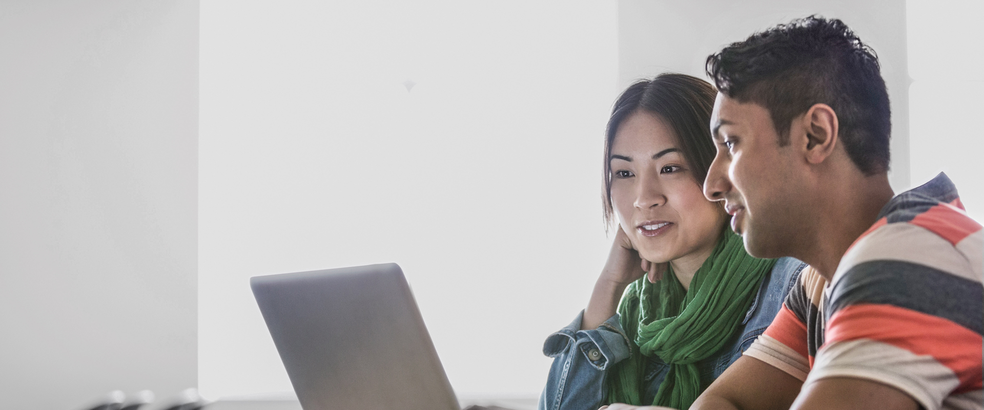 two people talking looking at a laptop