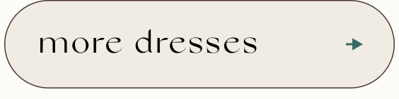 Text button reading 'more dresses' in black serif font on beige background with teal arrow on right side
