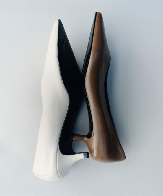 Three women's flat shoes arranged on white background: white, black, and taupe brown leather ballet flats.