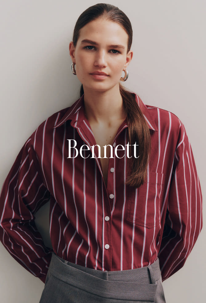 Woman wearing burgundy striped button-up shirt with gray pants against neutral background with text Bennett overlay