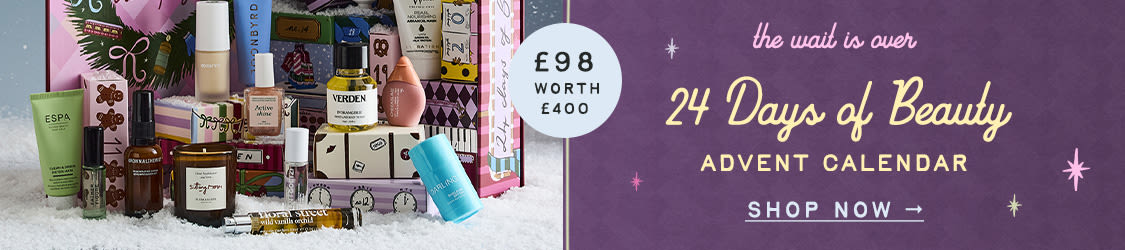 Beauty advent calendar with various skincare and cosmetic products displayed, text reads "the wait is over 24 Days of Beauty ADVENT CALENDAR"