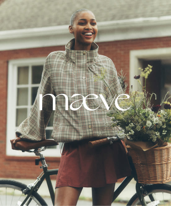 Smiling woman in plaid jacket standing with bicycle carrying flowers in basket, with text "maeve" overlaid