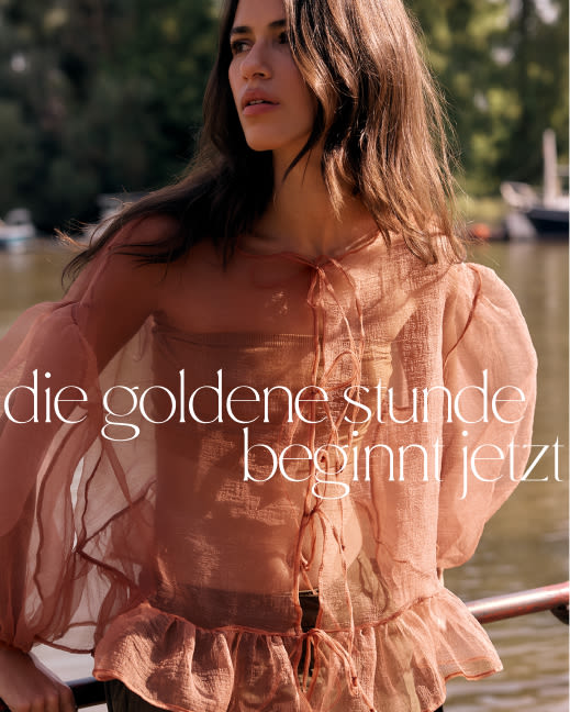 Woman in peach sheer blouse outdoors with text golden hour starts here in white lettering over sunlit background.