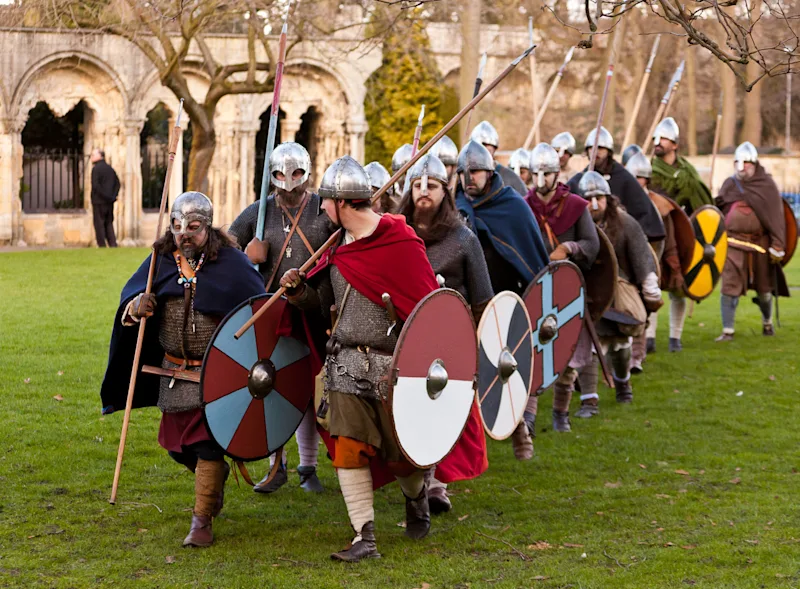 People dressed up as vikings marching in York for Jorvik Viking Festival, York, North Yorkshire, England, UK