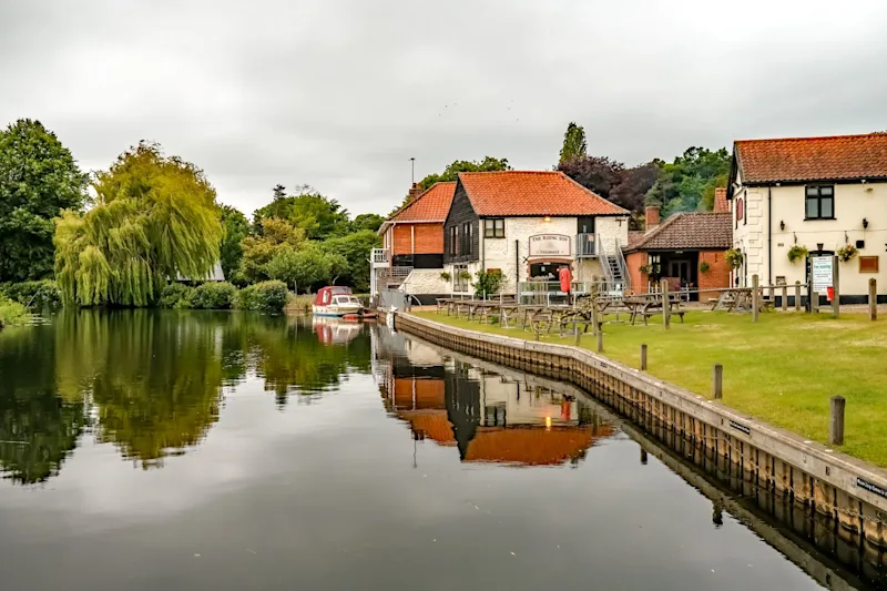 The Rising Sun pub on the River Bure in the village of Coltishall in the heart of the Norfolk Broads, UK