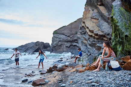 Family having fun on the beach at Sandymouth Holiday Resort (ATLA), Bude, Cornwall, England, UK