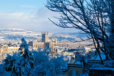 View of Bath Abbey and city skyline in the snow at winter, Bath, Somerset, Engand, UK