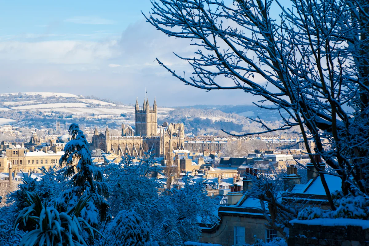 View of Bath Abbey and city skyline in the snow at winter, Bath, Somerset, Engand, UK