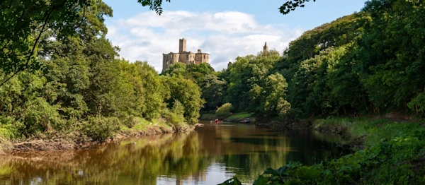 Warkworth Castle and the River Coquet in Morpeth, Northumberland, UK on a sunny day