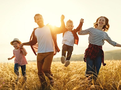 Happy family father of mother and child son on nature at sunset