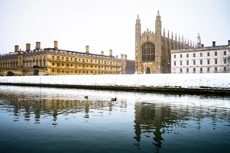A snowy King's Chapel in Cambridge in winter, next to the River Cam, England, UK