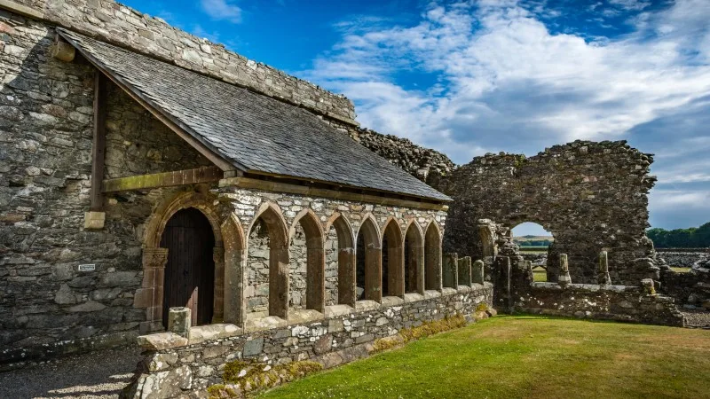 Ancient historic ruin of Glenluce Abbey Dumfries and Galloway, Scotland tourist attraction with row of stone arches.
