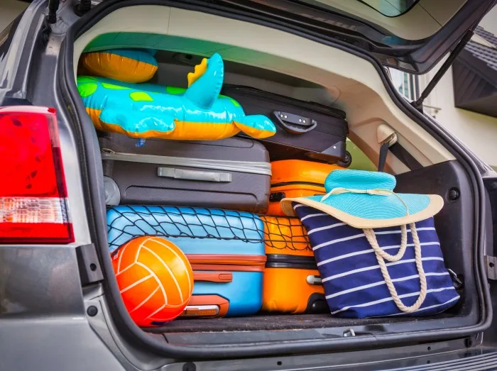 Baggages in the car trunk packed and ready to go for holidays