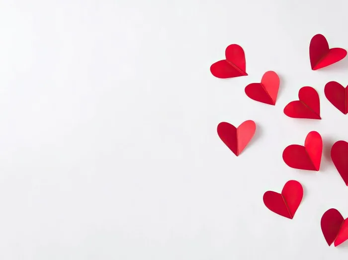 White background, flying red paper hearts, flat composition, free space for text or design, valentine's day celebration concept, love and romance theme, high resolution photography, stock photo style.