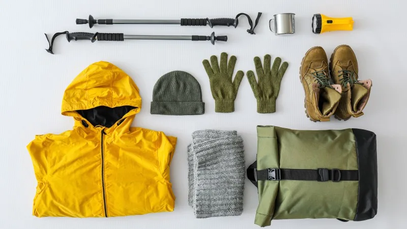 Equipment for hiking on light background