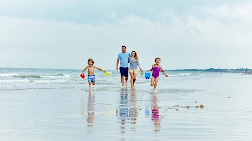 Family having fun on the beach in summer