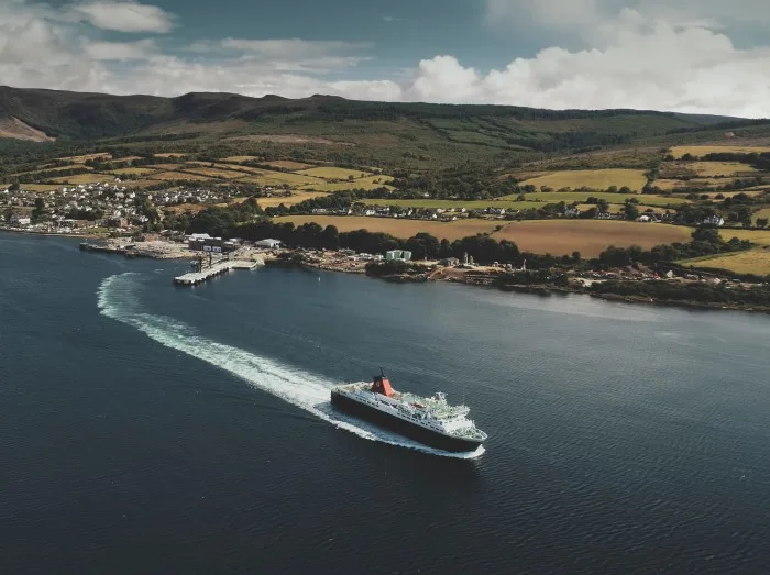Scotland, Brodick Ferry Terminus aerial panoramic shot of ship crossing, Arran Island.