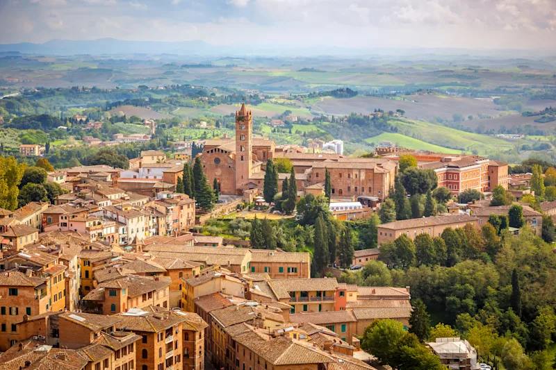 View of the historic city of Siena and the green hills of Tuscany, Italy