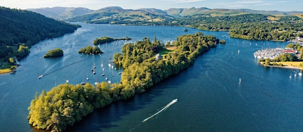 Windermere in the Lake District National Park, Cumbria, England. Aerial vista north over lake centre at Bowness marinas and Belle Isle. Summer evening