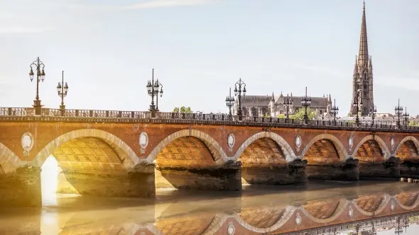 View on the famous saint Pierre bridge with saint Michael cathedral in Bordeaux city