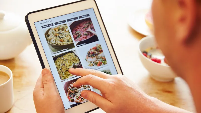 Person At Breakfast Looking At Recipe App On Digital Tablet