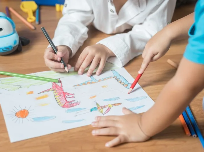 kid boy drawing with color pencils
