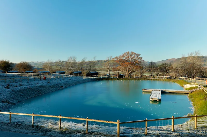 Beautiful winter scene at Love2Stay Mid Wales, with a snowy lake and views of the countryside, Wales, UK