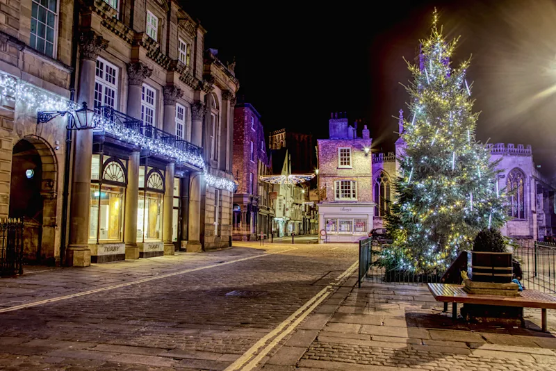 Historic streets of York with a Christmas tree lit up at night, Yorkshire, England, UK