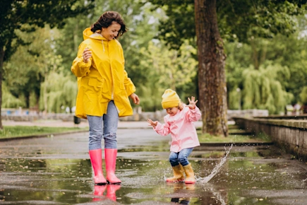 Mother and daughter having fun in the rain