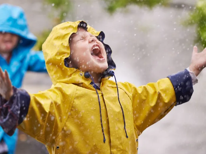 They love the rain. Shot of a young brother and sister playing in the rain.