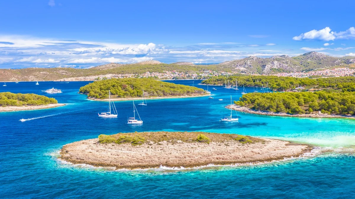 A breathtaking aerial view of the Pakleni Islands, Hvar, featuring the secluded Mlini Beach, surrounded by lush Mediterranean nature,