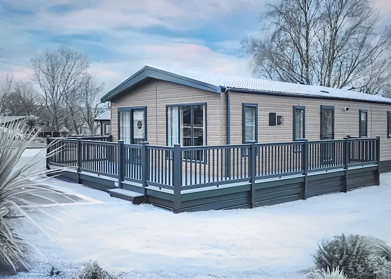 A snow-covered lodge at Wayfind Pennant Park (PENN) in Holywell, Flintshire, Wales