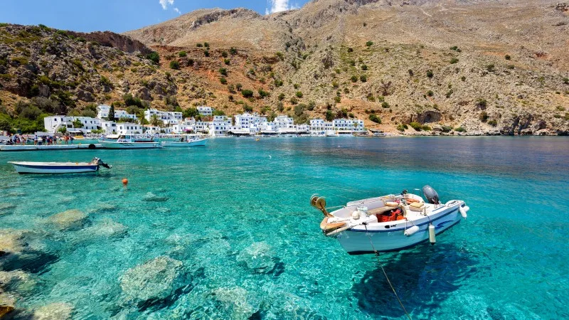 Small motorboat at clear water bay of Loutro town on Crete island, Greece